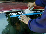 Installing the Jeep Thing sticker.