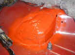 Extended t-case hump painted with 911T Tangerine. The 3/4" iron pipe cap is to raise the seat.