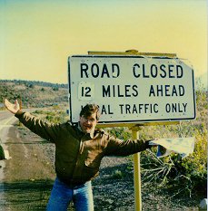 John with Map at "Road Closed" Sign